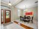 The dining room features a modern chandelier, artwork and dining room table for six at 3000 Naughton Way, Tarpon Springs, FL 34688