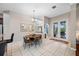 Cozy dining area offers natural light and flows seamlessly to the kitchen and an outdoor patio at 3000 Naughton Way, Tarpon Springs, FL 34688