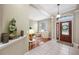 Spacious foyer featuring tile flooring, a Buddha statue, and a view into the living room at 3000 Naughton Way, Tarpon Springs, FL 34688