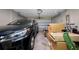View of garage filled with car and cardboard boxes with automatic door opener at 3000 Naughton Way, Tarpon Springs, FL 34688