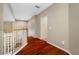 Hallway with hardwood floors, white trim and neutral walls at 3000 Naughton Way, Tarpon Springs, FL 34688