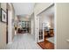 Hallway view of living room and office space with desk, chair, and decor at 3000 Naughton Way, Tarpon Springs, FL 34688