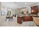Open-concept kitchen with a bar area, stainless appliances, granite counters, and a view into the living area at 3000 Naughton Way, Tarpon Springs, FL 34688