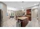 Open kitchen with granite countertops, stainless steel appliances, and a central island at 3000 Naughton Way, Tarpon Springs, FL 34688