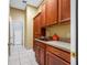 Laundry room features custom cabinets, countertops, a utility sink, and tile floor at 3000 Naughton Way, Tarpon Springs, FL 34688