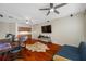 Bright living room with hardwood floors, ceiling fan, built-in bar and ample space at 3000 Naughton Way, Tarpon Springs, FL 34688