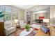 Bright living room with large windows and a view into the dining room at 3000 Naughton Way, Tarpon Springs, FL 34688