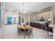 Bright dining area transitions smoothly to living room, featuring built-in shelving and a seamless flow at 3000 Naughton Way, Tarpon Springs, FL 34688