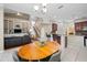Open concept living room showcases built-in shelving and seamless transition to kitchen and dining areas at 3000 Naughton Way, Tarpon Springs, FL 34688