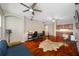 Open living room featuring hardwood floors, modern ceiling fans, and a built-in bar area at 3000 Naughton Way, Tarpon Springs, FL 34688