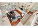 An aerial view of the open living area showing the hardwood floors, built-ins and stairway at 3000 Naughton Way, Tarpon Springs, FL 34688