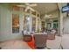 Covered outdoor patio with ceiling fans, comfortable seating, and view of backyard at 3000 Naughton Way, Tarpon Springs, FL 34688