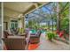 Enjoy outdoor living in this screened patio with ample seating, a ceiling fan, and pool views with waterfall feature at 3000 Naughton Way, Tarpon Springs, FL 34688
