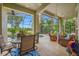 Enjoy this screened patio with ample seating and dining area, offering beautiful views of the pool and serene water feature at 3000 Naughton Way, Tarpon Springs, FL 34688