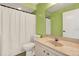Bright bathroom with a large mirror and green colored walls at 3146 37Th S Ln # A, St Petersburg, FL 33711