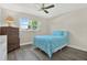 Cozy bedroom featuring a ceiling fan, light walls and wood-look floors at 3146 37Th S Ln # A, St Petersburg, FL 33711