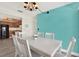 Dining room featuring a table, six chairs, a chandelier and a turquoise accent wall at 3146 37Th S Ln # A, St Petersburg, FL 33711