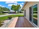Tiled patio with sliding doors to a bright home near a green lawn and mature trees at 3146 37Th S Ln # A, St Petersburg, FL 33711