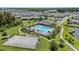 Aerial view of the community pool, clubhouse, tennis court and surrounding landscaping and trees at 32193 Watoga Loop, Wesley Chapel, FL 33543
