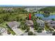 An aerial view of a residential home within a picturesque neighborhood near a lake at 32193 Watoga Loop, Wesley Chapel, FL 33543