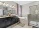 This bathroom features double sinks, a tub, and a glass shower enclosure at 32193 Watoga Loop, Wesley Chapel, FL 33543