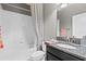This bathroom has a shower and tub combination, modern fixtures and a granite countertop at 32193 Watoga Loop, Wesley Chapel, FL 33543