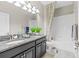 Well-lit bathroom with double vanity, granite countertops, and a shower-tub combo, offering a clean modern space at 32193 Watoga Loop, Wesley Chapel, FL 33543