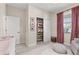 Bedroom with an organized closet, soft lighting, and stylish decor, creating a warm and inviting space at 32193 Watoga Loop, Wesley Chapel, FL 33543