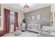 Cozy Bedroom with a crib, soft lighting, and stylish decor, creating a warm and inviting space at 32193 Watoga Loop, Wesley Chapel, FL 33543