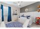 Themed bedroom with blue accents, a bed with slide, and playful decor creates a fun and imaginative space at 32193 Watoga Loop, Wesley Chapel, FL 33543