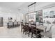 Open concept dining area with a large wooden table, chairs, and a view into the kitchen at 32193 Watoga Loop, Wesley Chapel, FL 33543