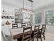 Inviting dining area with large wood table, ample seating, custom wine storage, and lots of natural light at 32193 Watoga Loop, Wesley Chapel, FL 33543