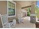 Inviting front porch with rocking chairs offers a relaxing spot to enjoy the outdoors at 32193 Watoga Loop, Wesley Chapel, FL 33543