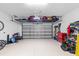 Spacious two-car garage features epoxy flooring and overhead storage racks at 32193 Watoga Loop, Wesley Chapel, FL 33543