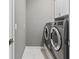 This laundry room features modern washer and dryer appliances and overhead cabinets at 32193 Watoga Loop, Wesley Chapel, FL 33543