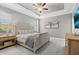 Comfortable main bedroom featuring a ceiling fan, tray ceiling, and neutral decor at 32193 Watoga Loop, Wesley Chapel, FL 33543