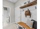 This mudroom features a bench, hooks, and a shiplap accent wall at 32193 Watoga Loop, Wesley Chapel, FL 33543
