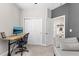 This room features an office space, closet, gray accent wall, and a view of another room at 32193 Watoga Loop, Wesley Chapel, FL 33543