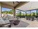 Inviting outdoor living area with comfortable seating, fire pit, and dining space, perfect for entertaining at 32193 Watoga Loop, Wesley Chapel, FL 33543