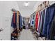 Spacious walk-in closet with plenty of hanging space for clothes and shoe racks at 32193 Watoga Loop, Wesley Chapel, FL 33543