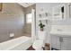 Updated bathroom features modern tiling, a bathtub with shower, and a stylish vanity at 3230 4Th S Ave, St Petersburg, FL 33712