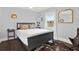 Cozy bedroom features a comfortable bed, modern decor, and natural light from the window at 3230 4Th S Ave, St Petersburg, FL 33712