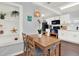 Bright dining area featuring a wooden table, shelving, and view into the kitchen at 3230 4Th S Ave, St Petersburg, FL 33712