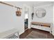 Inviting foyer with dark floors, round mirror, and a storage bench with drawers at 3230 4Th S Ave, St Petersburg, FL 33712