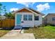 Charming bungalow featuring a light blue front door and well-maintained landscaping at 3230 4Th S Ave, St Petersburg, FL 33712