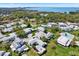 Stunning aerial view of a condo community with a pool, trees, and a view of a large body of water in the background at 3268 39Th S St # A, St Petersburg, FL 33711