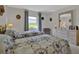 Inviting bedroom with twin beds, a window view, and a dresser, decorated with vintage-style hats at 3268 39Th S St # A, St Petersburg, FL 33711