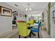Dining room with glass table, colorful chairs, a large mirror, and an open view of the kitchen area at 3268 39Th S St # A, St Petersburg, FL 33711