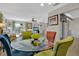 Bright dining area next to the living room featuring a glass table, colorful chairs, and lots of light at 3268 39Th S St # A, St Petersburg, FL 33711