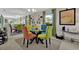 Bright dining area with a glass table, colorful chairs, and many decorative pictures on the walls at 3268 39Th S St # A, St Petersburg, FL 33711